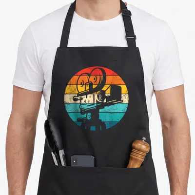Tablier de cuisine noir avec illustration d'appareil photo pour réalisation de films sur fond circulaire arc-en-ciel vintage