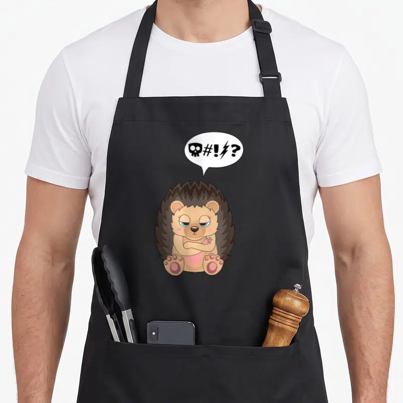 Tablier de cuisine noir avec illustration d'un hérisson aux bras croisés et bulle de dialogue symbolique.