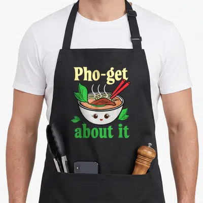 Tablier de cuisine noir avec illustration d'un bol de pho souriant et paires de baguettes rouges