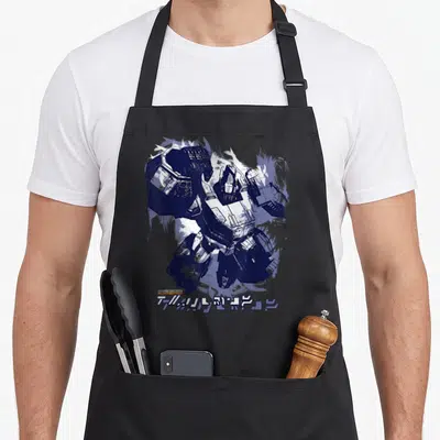 Tablier de cuisine noir avec une illustration d'Optimus Prime en peinture bleue et blanche, signature en bas à gauche.