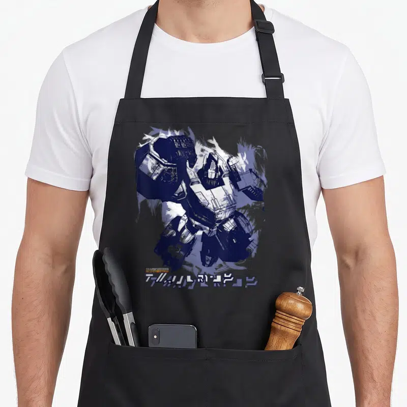Tablier de cuisine noir avec une illustration d'Optimus Prime en peinture bleue et blanche, signature en bas à gauche.