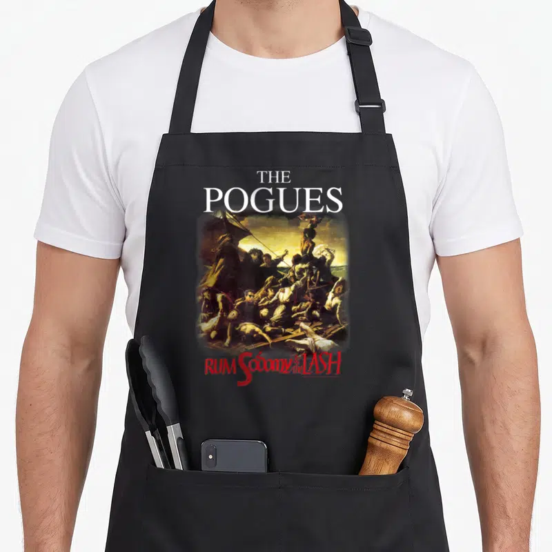 Tablier de cuisine noir avec une illustration maritime classique et le texte The Pogues Rum Sodomy « and the » Lash en rouge et blanc.