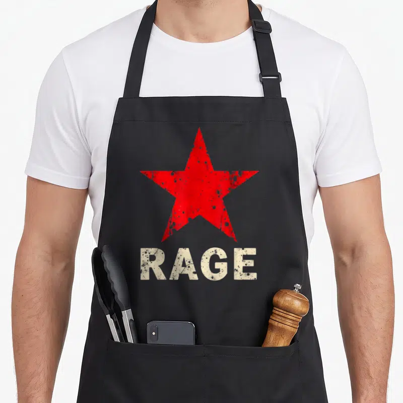 Tablier de cuisine noir avec une grande étoile rouge texturée et le mot RAGE en blanc délavé en bas.