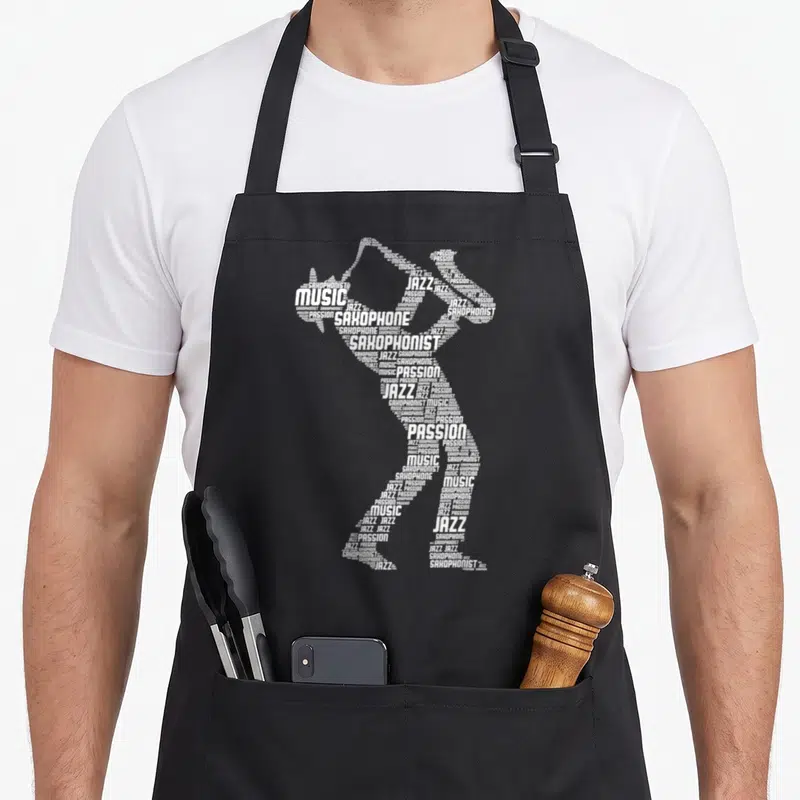 Tablier de cuisine noir avec silhouette de saxophoniste constituée de mots blancs jazz et musique.