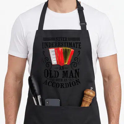 Tablier de cuisine noir avec illustration d'un accordéon rouge et texte vintage sur le devant.