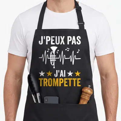 Tablier de cuisine noir avec inscription Je peux pas j'ai trompette et illustration de cuivre blanc intégré à une onde sonore jaune et blanche.