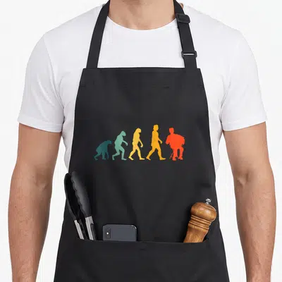 Tablier de cuisine noir avec silhouettes colorées représentant l'évolution humaine vers un musicien d'accordéon.