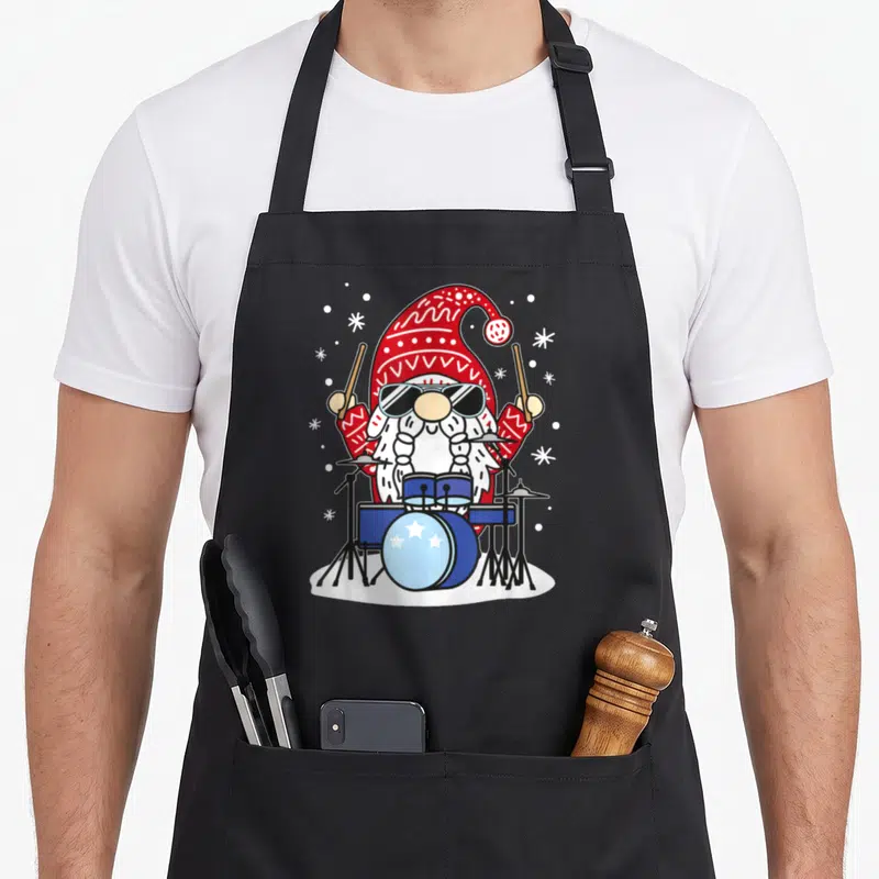 Tablier de cuisine noir avec un nain de Noël jouant de la batterie et portant des lunettes noires.