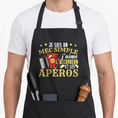 Tablier de cuisine noir avec illustration d'accordéon, verre et texte humoristique jaune et blanc.