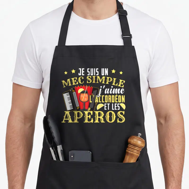 Tablier de cuisine noir avec illustration d'accordéon, verre et texte humoristique jaune et blanc.