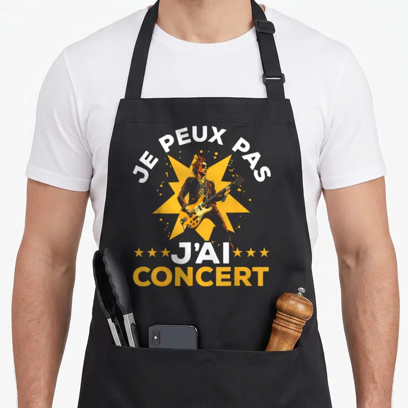 Tablier de cuisine noir avec illustration guitariste et texte Je peux pas j'ai concert en blanc et orange.