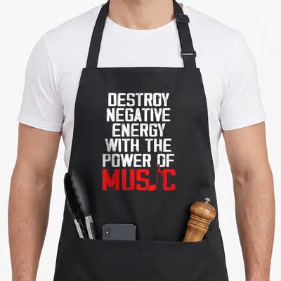 Tablier de cuisine noir avec inscription blanche et rouge Destroy negative energy the power of music et une note de musique intégrée au mot Music.