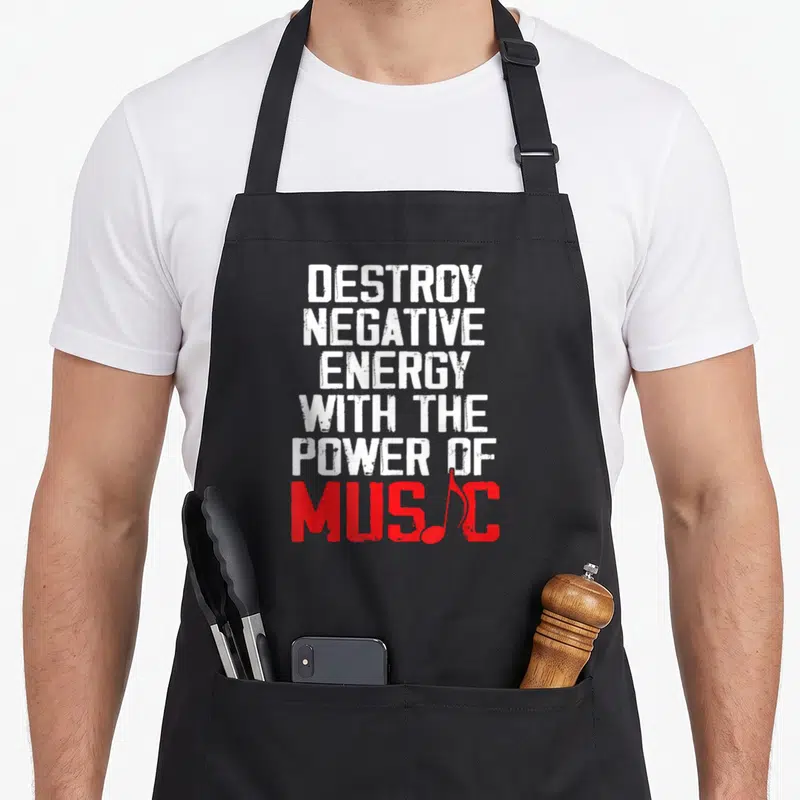 Tablier de cuisine noir avec inscription blanche et rouge Destroy negative energy the power of music et une note de musique intégrée au mot Music.