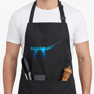 Tablier de cuisine noir avec un clavier piano bleu dont les touches s'envolent sous forme de notes de musique stylisées.