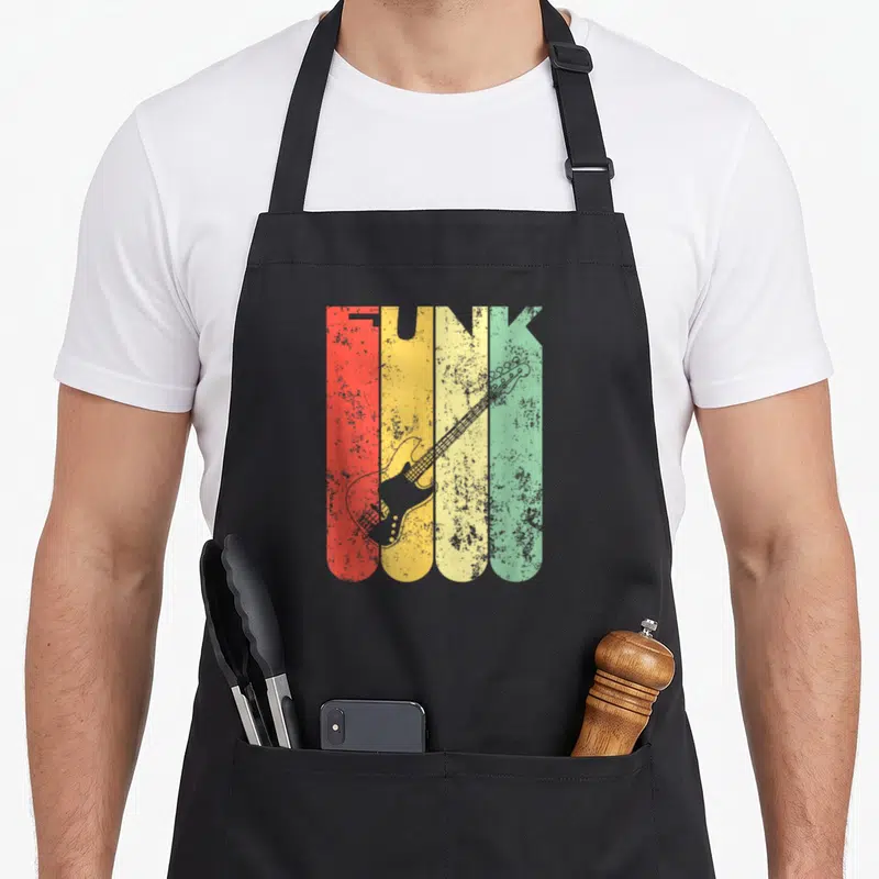 Tablier de cuisine noir avec le mot FUNK en lettres colorées et une illustration de basse électrique vintage superposée.