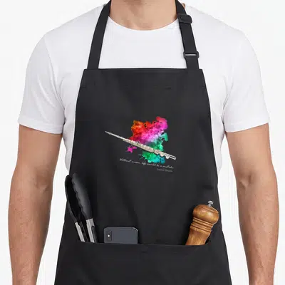 Tablier de cuisine noir avec une flûte traversière colorée et une citation en anglais.