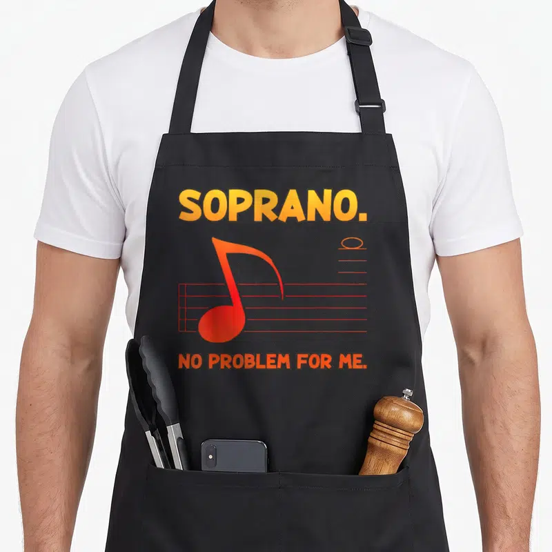 Tablier de cuisine noir avec inscription SOPRANO. et une note de musique rouge sur portée.