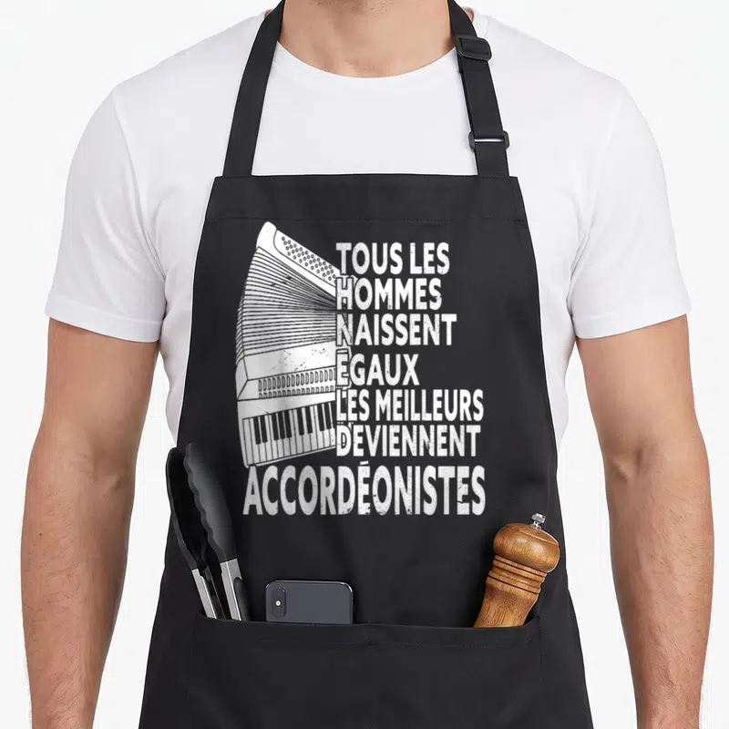 Tablier de cuisine noir avec illustration d'accordéon et texte blanc tous les hommes naissent égaux accordéonistes