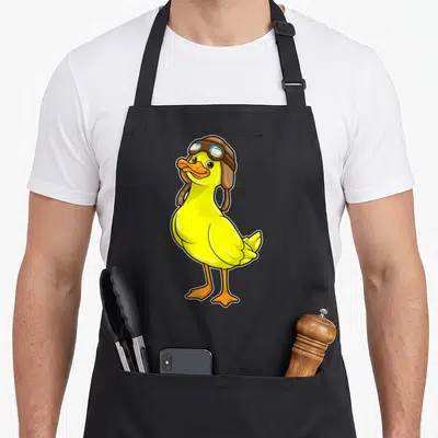 Tablier de cuisine noir avec illustration d'un canard jaune portant un casque de pilote en cuir marron et des lunettes de vol.