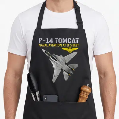 Tablier de cuisine noir avec illustration d'un avion F-14 Tomcat et ailes dorées.