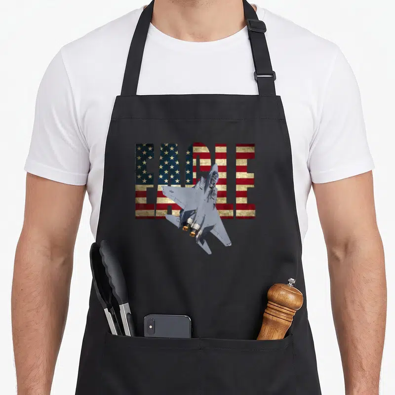 Tablier de cuisine noir avec illustration F-15 Eagle et texte EAGLE au motif drapeau américain.