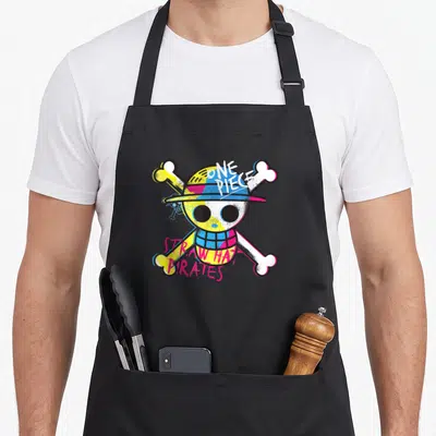 Tablier de cuisine noir avec logo Straw Hat Pirates chapeau de paille coloré et os croisés.