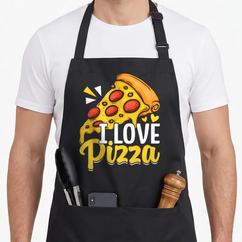 Tablier de cuisine noir avec une illustration colorée d'une tranche de pizza et du texte blanc I Love Pizza.