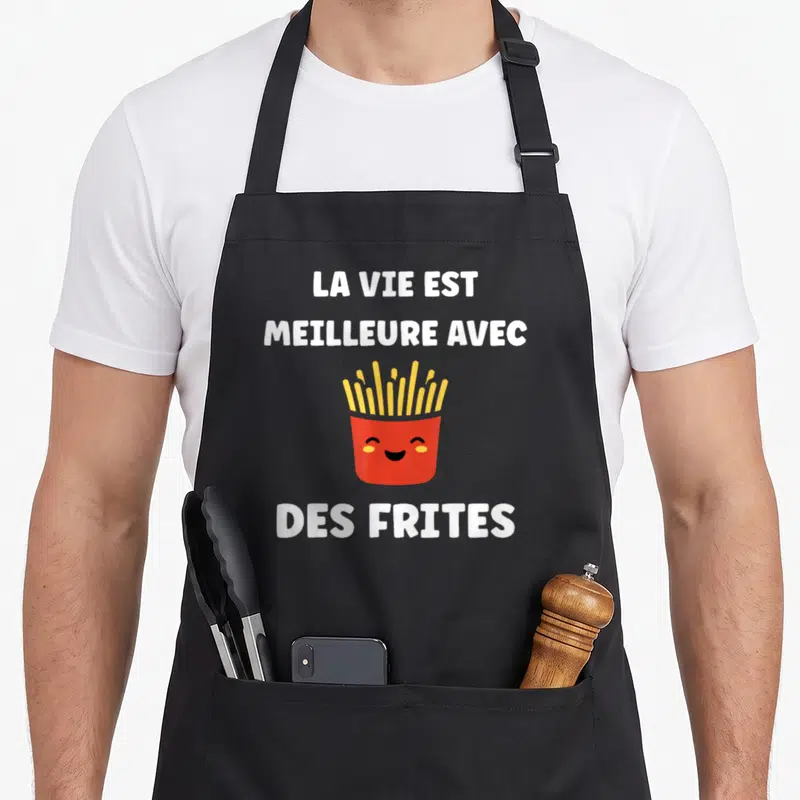Tablier de cuisine noir avec une illustration de frites dans une boîte rouge et un message humoristique en lettres blanches.