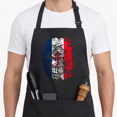 Tablier de cuisine noir avec illustration d'un soldat en tenue tactique sur fond de drapeau français et croix de Lorraine.