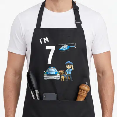Tablier de cuisine noir avec illustration d'un agent de police, d'un chien, d'une voiture et d'un hélicoptère.