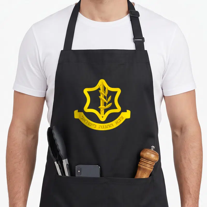 Tablier de cuisine noir avec emblème doré représentant une épée et une branche d'olivier au centre d'une étoile.