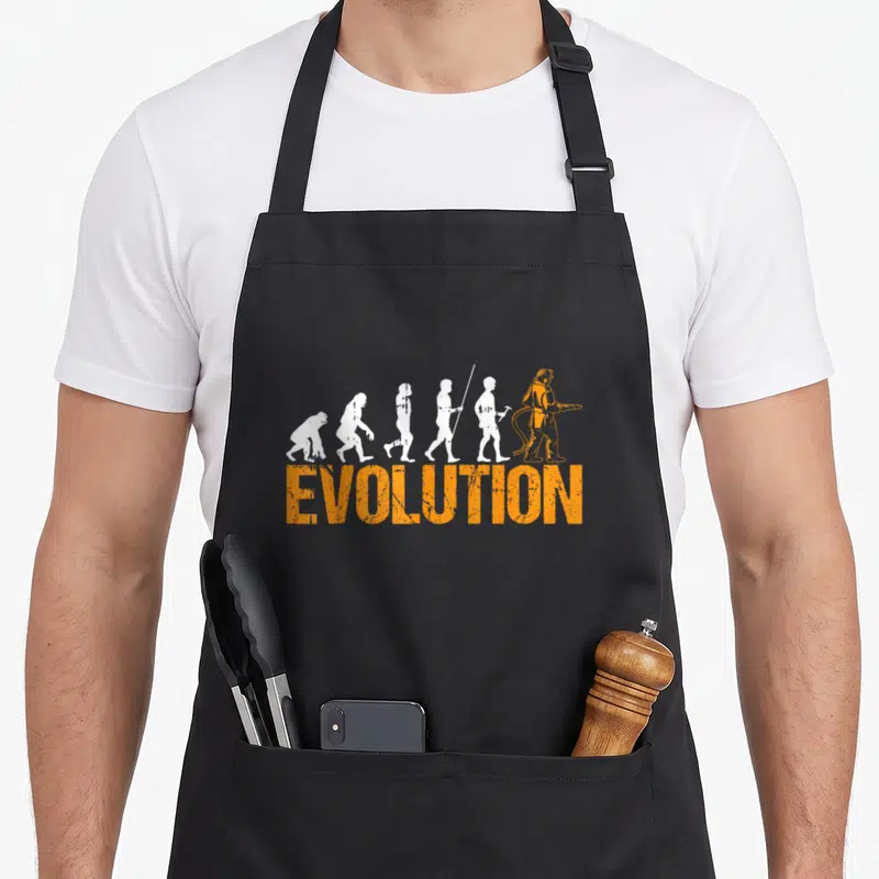 Tablier de cuisine noir avec silhouette evolution homme pompier orange et texte evolution en lettres capitales oranges.