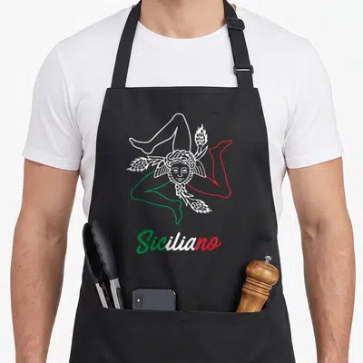 Tablier de cuisine noir avec une illustration blanche de Trinacria et le mot Siciliano en vert, blanc et rouge.