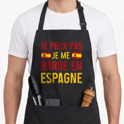 Tablier de cuisine noir avec l'inscription Je peux pas je me barre en Espagne et deux drapeaux espagnols.