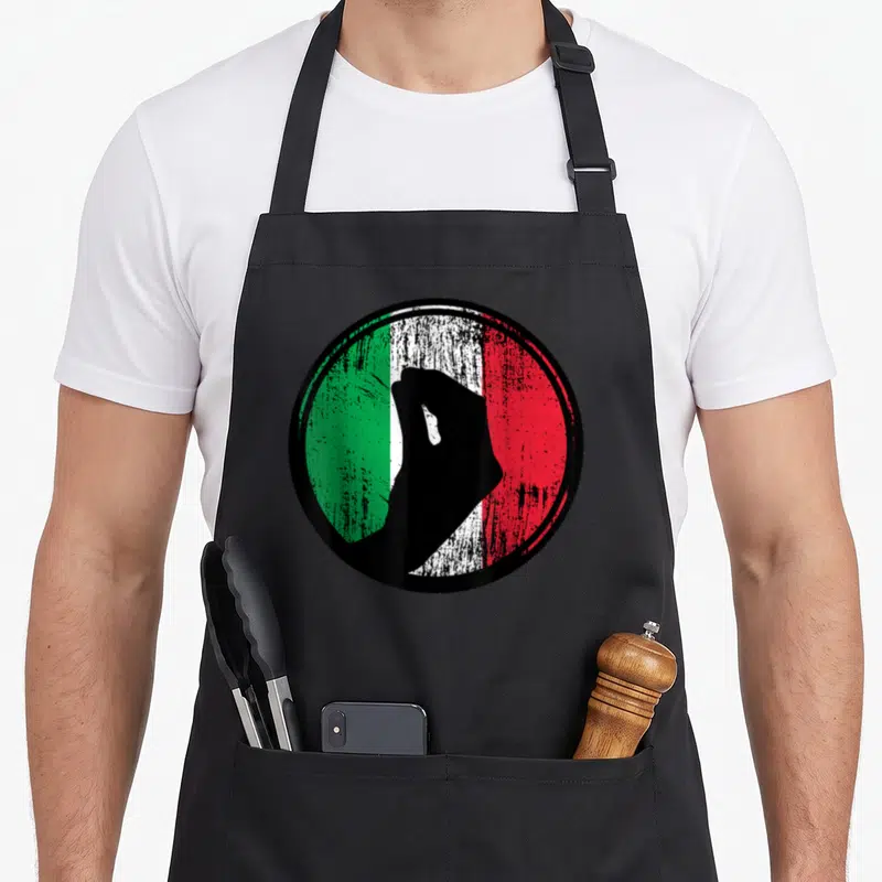 Tablier de cuisine noir avec main italienne fermée sur fond de drapeau Italia vert blanc et rouge dans un cercle.