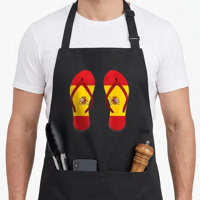 Tablier de cuisine noir avec une illustration de tongs aux couleurs du drapeau espagnol et son blason central.