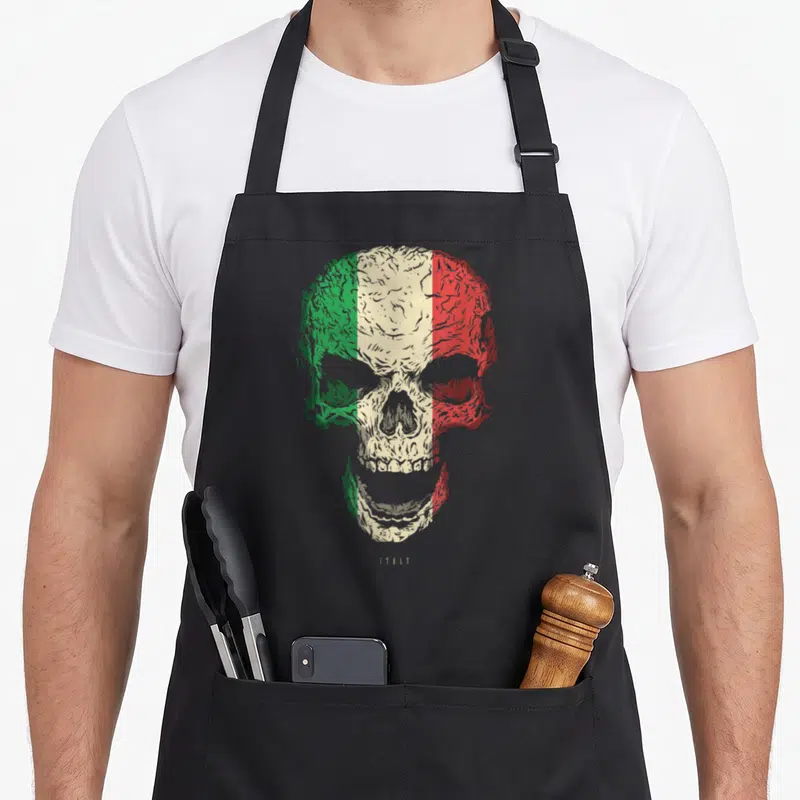 Tablier de cuisine noir avec crâne stylisé aux couleurs du drapeau italien et l'inscription Italy en bas.