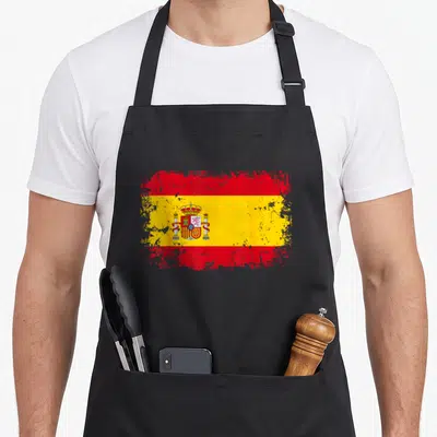 Tablier de cuisine noir avec le drapeau Espagne Espana aux couleurs vives et effet usé sur les bords.