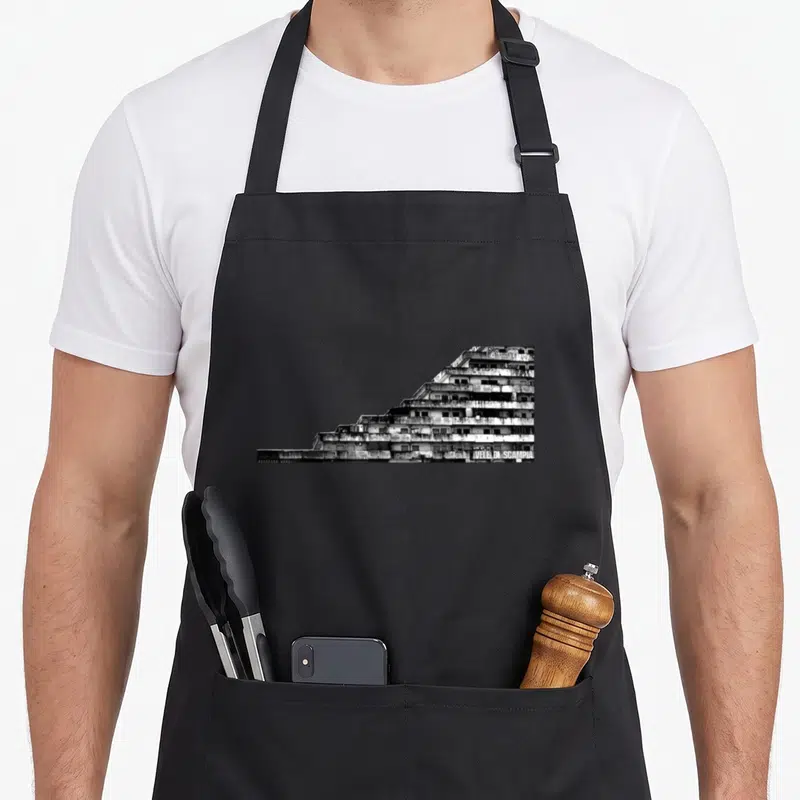Tablier de cuisine noir avec une impression graphique en noir et blanc représentant les tours des Vele Di Scampia à Naples, Italie.