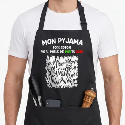 Tablier de cuisine noir avec inscription Mon Pyjama et illustration de poils blancs stylisés.