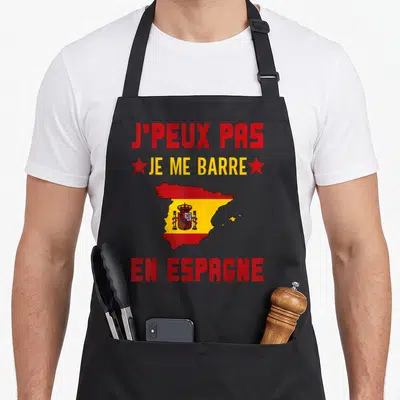 Tablier de cuisine noir avec texte rouge et jaune et carte d'Espagne ornée du drapeau national au centre.