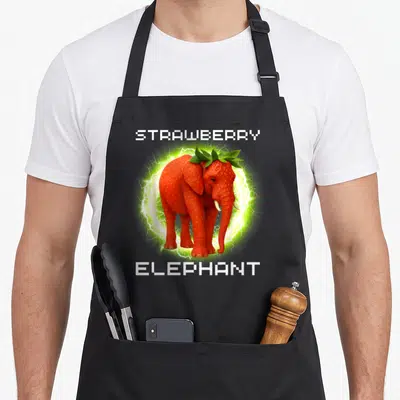 Tablier de cuisine noir avec un éléphant fraise entouré d'éclairs verts et le texte STRAWBERRY ELEPHANT en blanc.