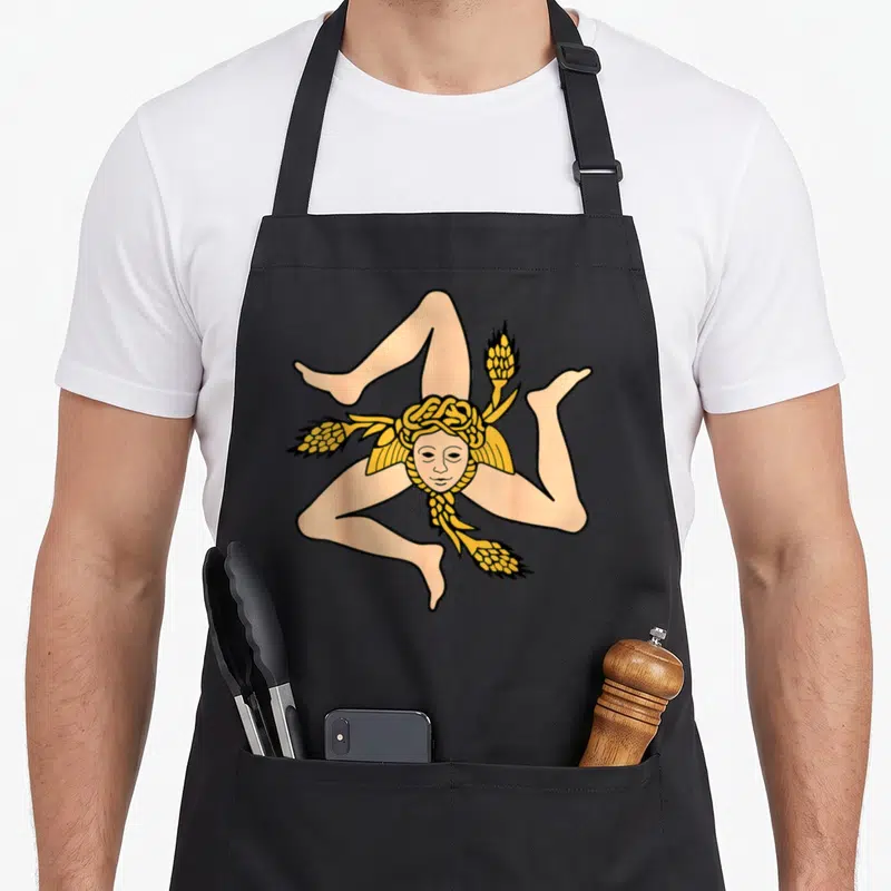 Tablier de cuisine noir avec illustration colorée d'une figure à trois jambes et épis de wheat dorés.