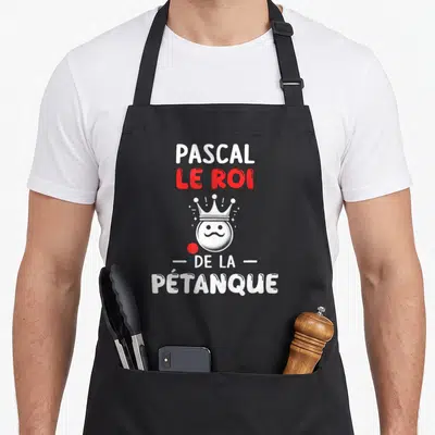 Tablier de cuisine noir avec inscription Pascal le roi de la pétanque et boule à moustache couronnée.