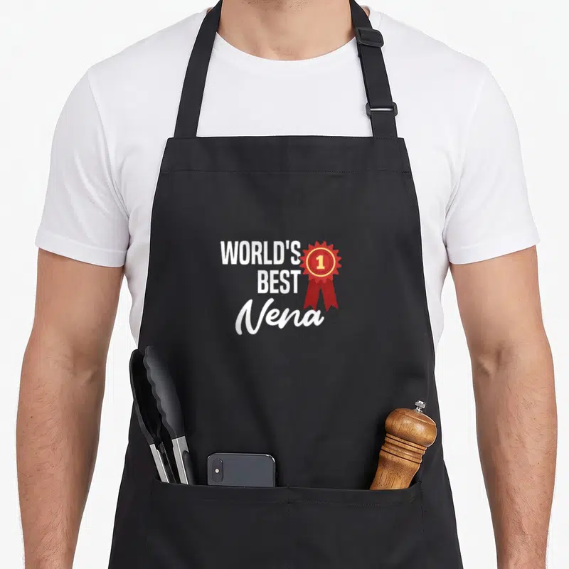 Tablier de cuisine noir avec l'inscription World's Best Nena et une médaille rouge portant le chiffre 1.