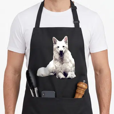 Tablier de cuisine noir avec illustration d'un Berger suisse blanc assis et souriant