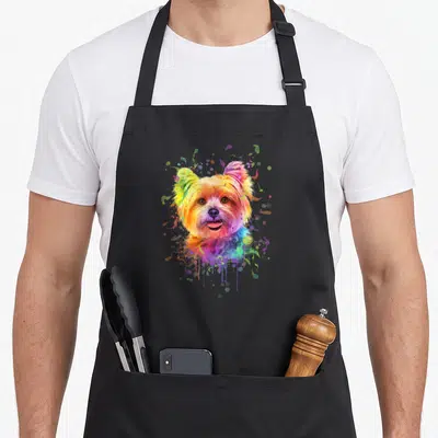 Tablier de cuisine noir avec portrait artistique d'un chien Yorkshire aux couleurs vives et éclaboussures multicolores.