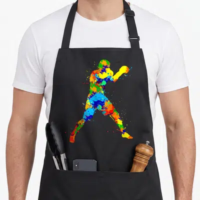 Tablier de cuisine noir avec silhouette de boxer aux couleurs vives et éclaboussures artistiques multicolores.