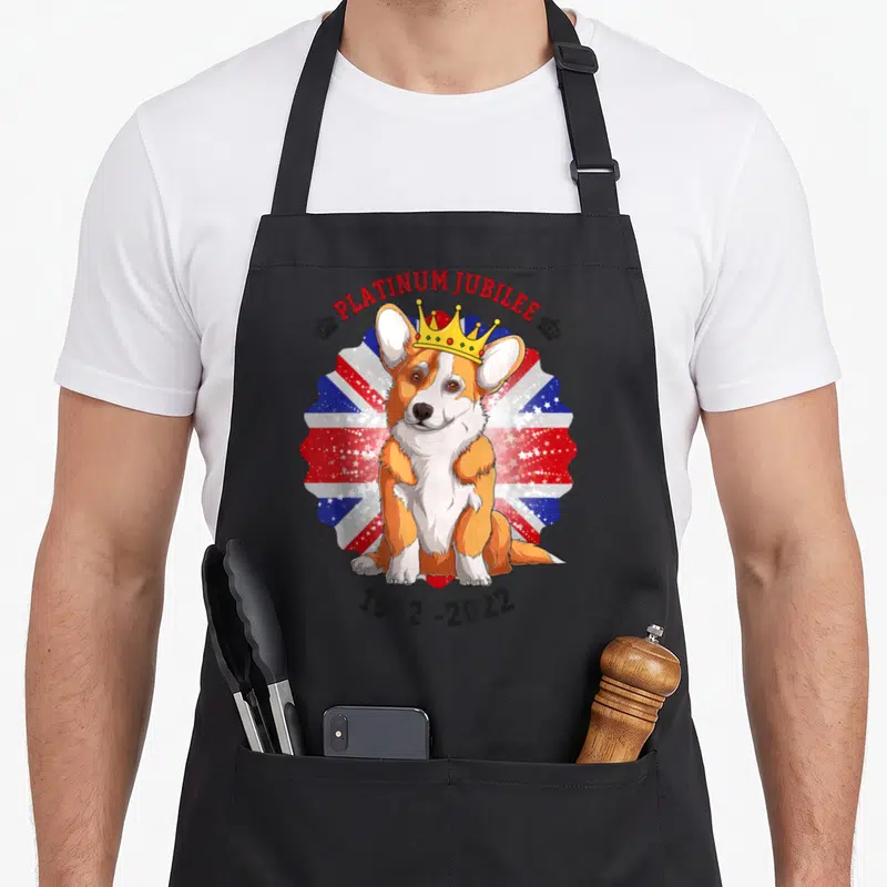 Tablier de cuisine noir avec un Corgi couronné sur fond Union Jack et texte Platinum Jubilee 1952-2022