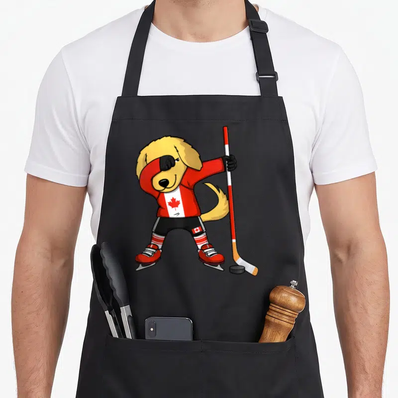 Tablier de cuisine noir avec un Golden Retriever en tenue de hockey sur glace effectuant un mouvement de danse dab.